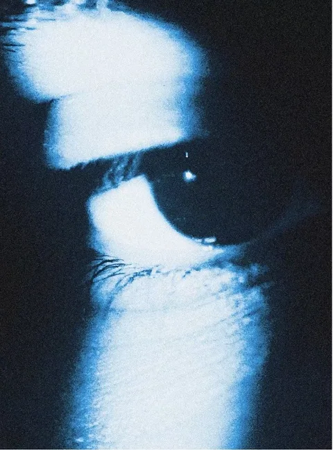 Close-up of an eye in blue light
